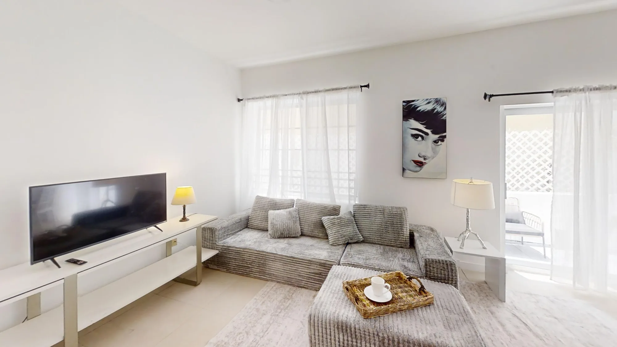 Furnished living area with the door to the patio, at 130 3rd St